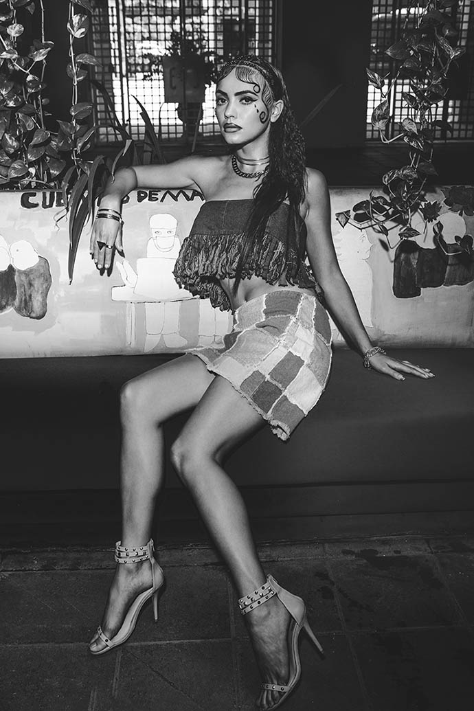 Curb Chain Toggle Necklace: Michael Kors  Cage Choker Necklace: Gabriela Artigas  Gold Ring Set: H&M  Denim Fringe Bandeau: A.B Hombre by Z. De Sousa & A. Beltran Blue Denim Patchwork Skirt: Zanadi  Studded Triple Strap Sandals: Schutz 