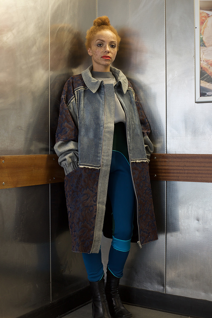 Coral wears: Top by Hayley Young, Coat by Sarah Kate Holmes & Highwaisted trousers by Keala Seitz., Boots - Vintage Clarks from Rokit