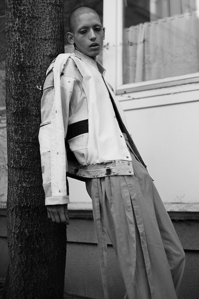 Thiago wears jacket by Fade Out Label and trousers by KATKOVTA