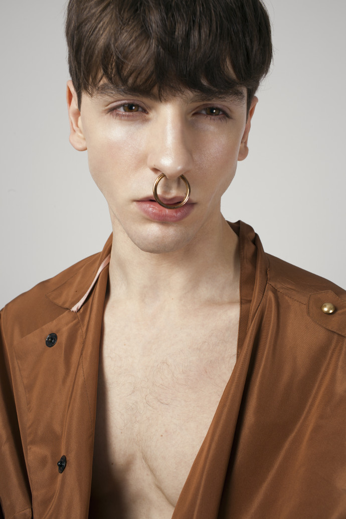 Gabriel is wearing jacket by Atu Body Couture and earring by Renard