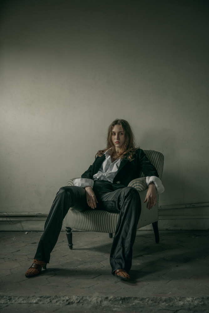 White shirt by Hugo Boss Velvet jacket by Maria Aristidou Asymmetrical trousers by Patuna Boots - Stylist’s own Ring by Harpo