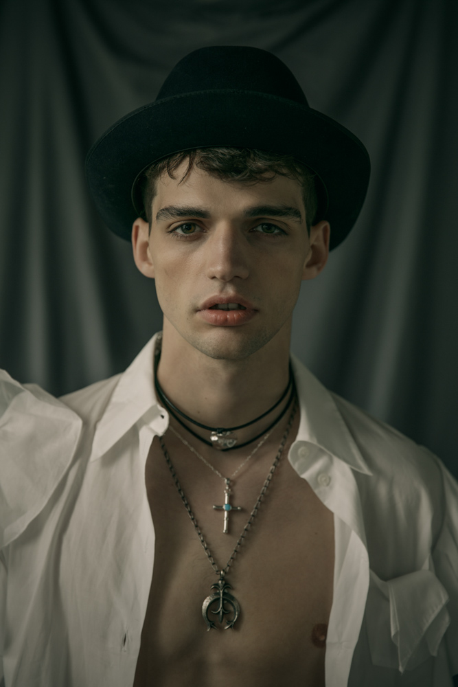 White shirt with ruffles by Viktor&Rolf Hat by Laurence Bossion Cross necklace, sailor wheel necklace by Harpo Gold plated metal, leather necklace from Nature collection by Delphine-Charlotte Parmentier 