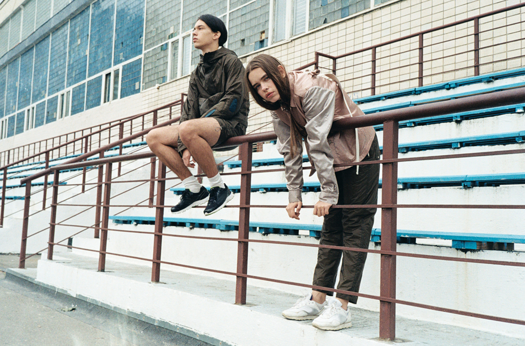 HER - Jacket, Top & Bottoms by Sasha Kanevski Shoes by Nike HIM - Jacket & Shorts by Sasha Kanevski Shoes by New Balance