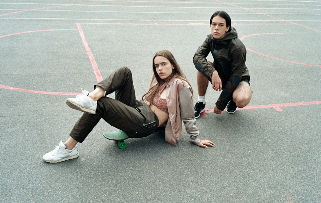 HER - Jacket, Top & Bottoms by Sasha Kanevski Shoes by Nike HIM - Jacket & Shorts by Sasha Kanevski Shoes by New Balance