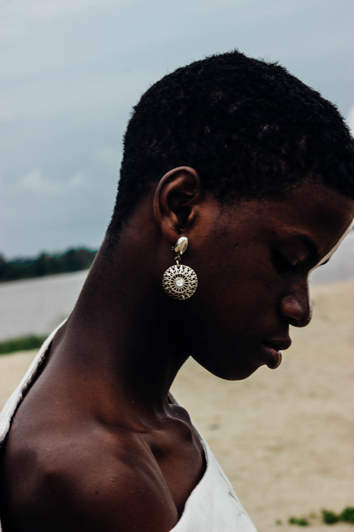 White slanted Sleevless tunic : Nkwo Grey trousers : Stylist Wardrobe