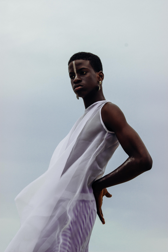 White sheer dress: Nkwo Stripped coloured aso-oke pants: Nkwo Earrings: Stylist Wardrobe