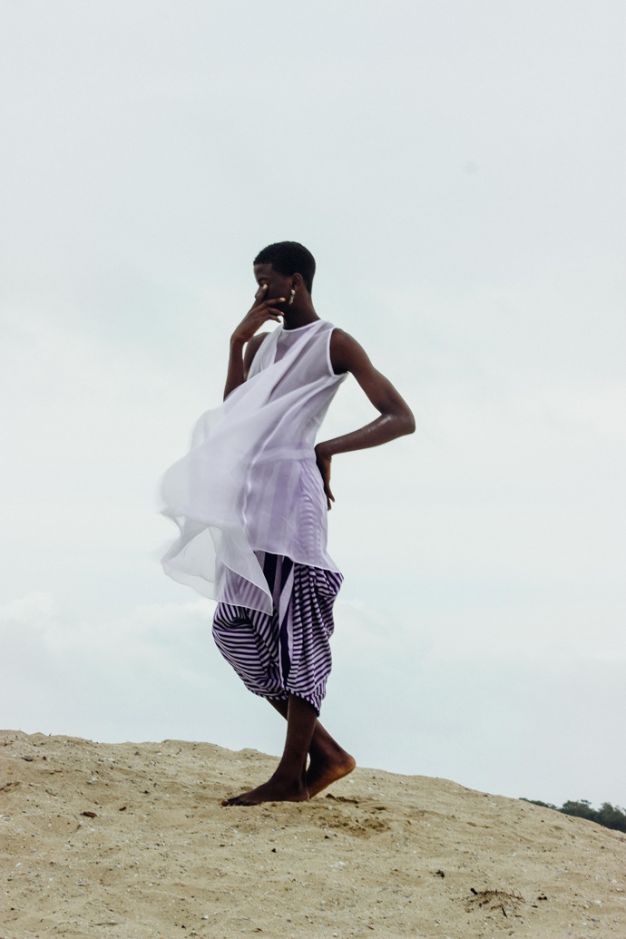 White sheer dress: Nkwo Stripped coloured aso-oke pants: Nkwo Earrings: Stylist Wardrobe