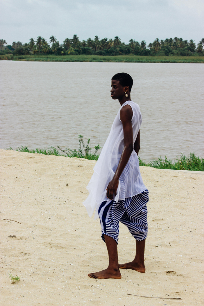 White sheer dress: Nkwo Stripped coloured aso-oke pants: Nkwo Earrings: Stylist Wardrobe
