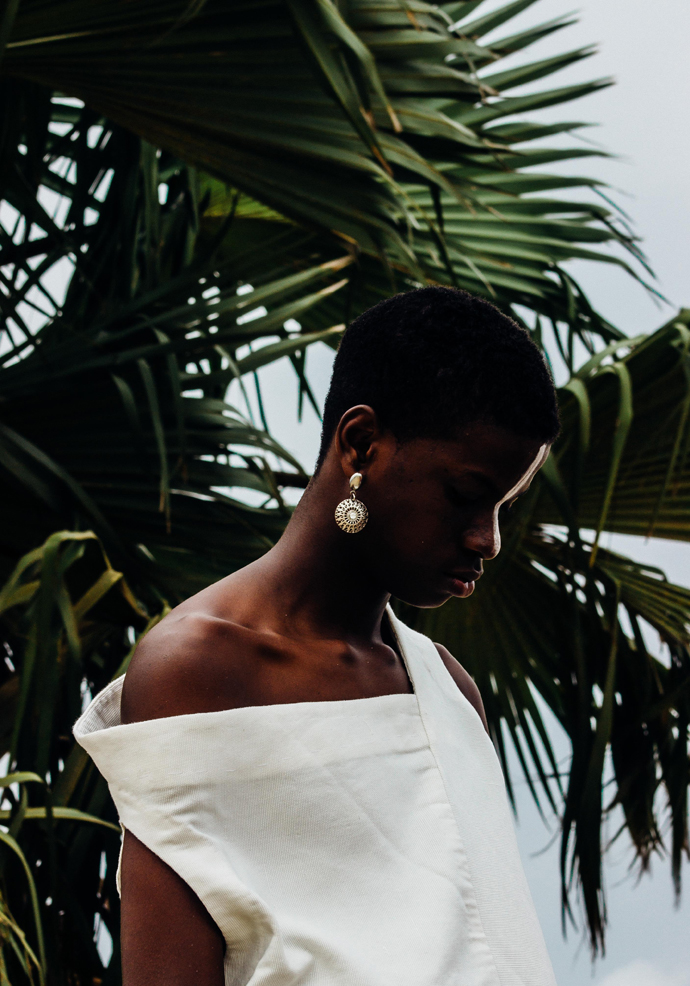 White slanted Sleevless tunic : Nkwo Grey trousers : Stylist Wardrobe