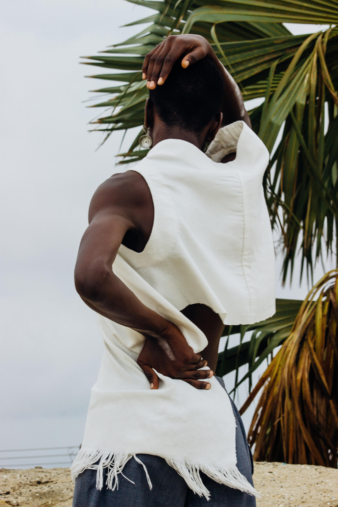 White slanted Sleevless tunic : Nkwo Grey trousers : Stylist Wardrobe