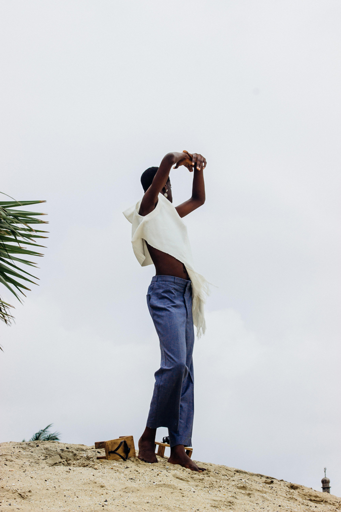 White slanted Sleevless tunic : Nkwo Grey trousers : Stylist Wardrobe