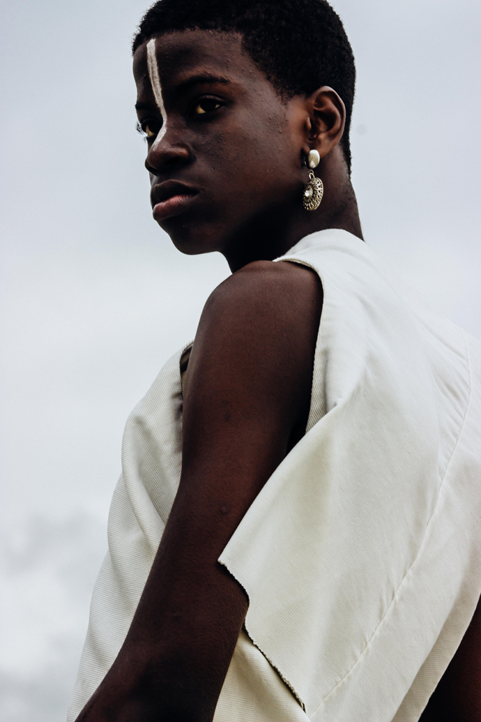 White slanted Sleevless tunic : Nkwo Grey trousers : Stylist Wardrobe