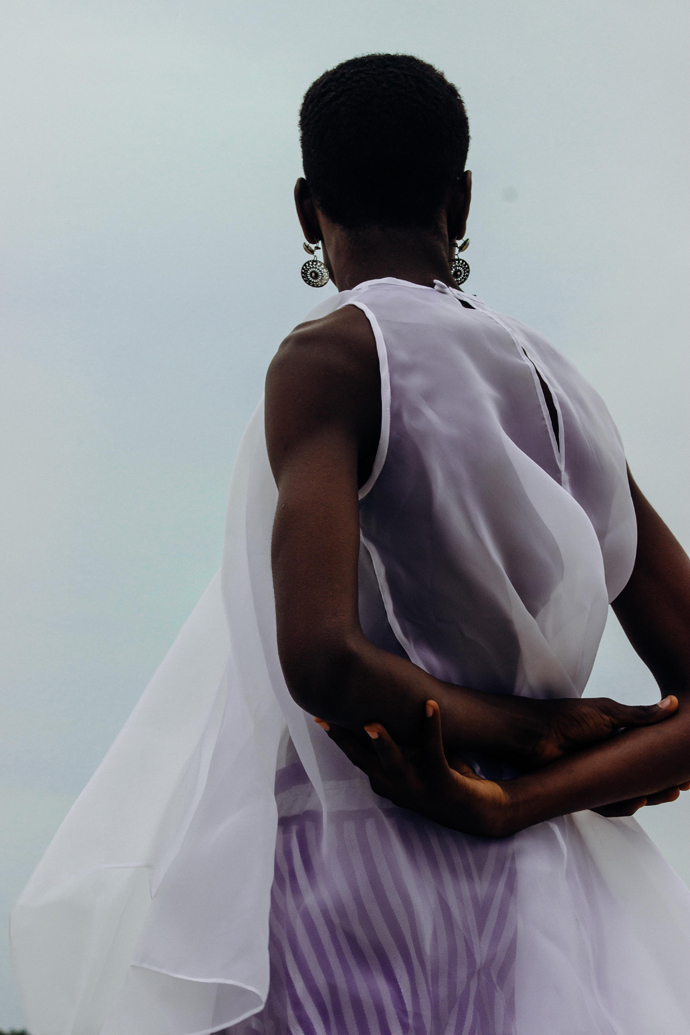 White sheer dress: Nkwo Stripped coloured aso-oke pants: Nkwo Earrings: Stylist Wardrobe
